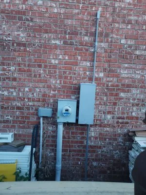 Exterior electric meter and service equipment on a brick wall