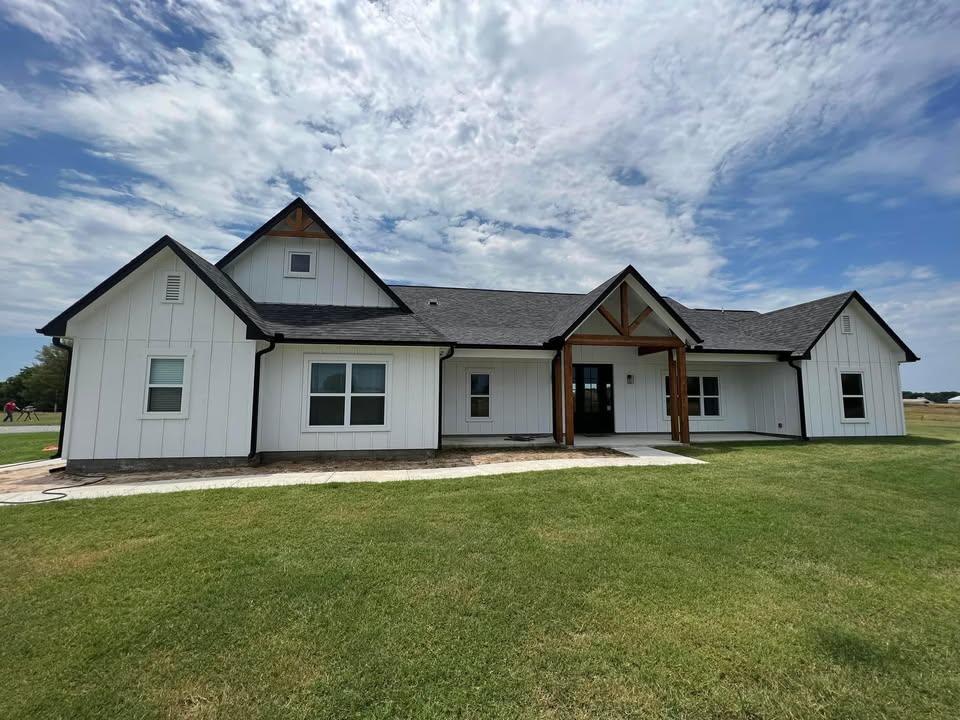 Black seamless gutters on a white farmhouse — Crowson Seamless job