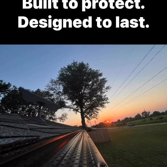 Leaf guard installed on a dark seamless gutter at dusk