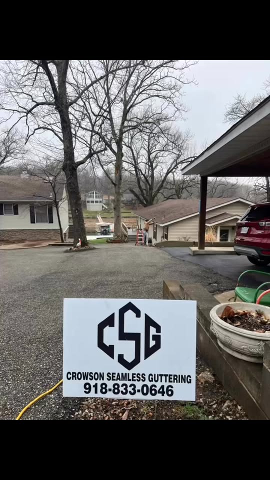 Crowson Seamless yard sign and gutter crew on a residential job