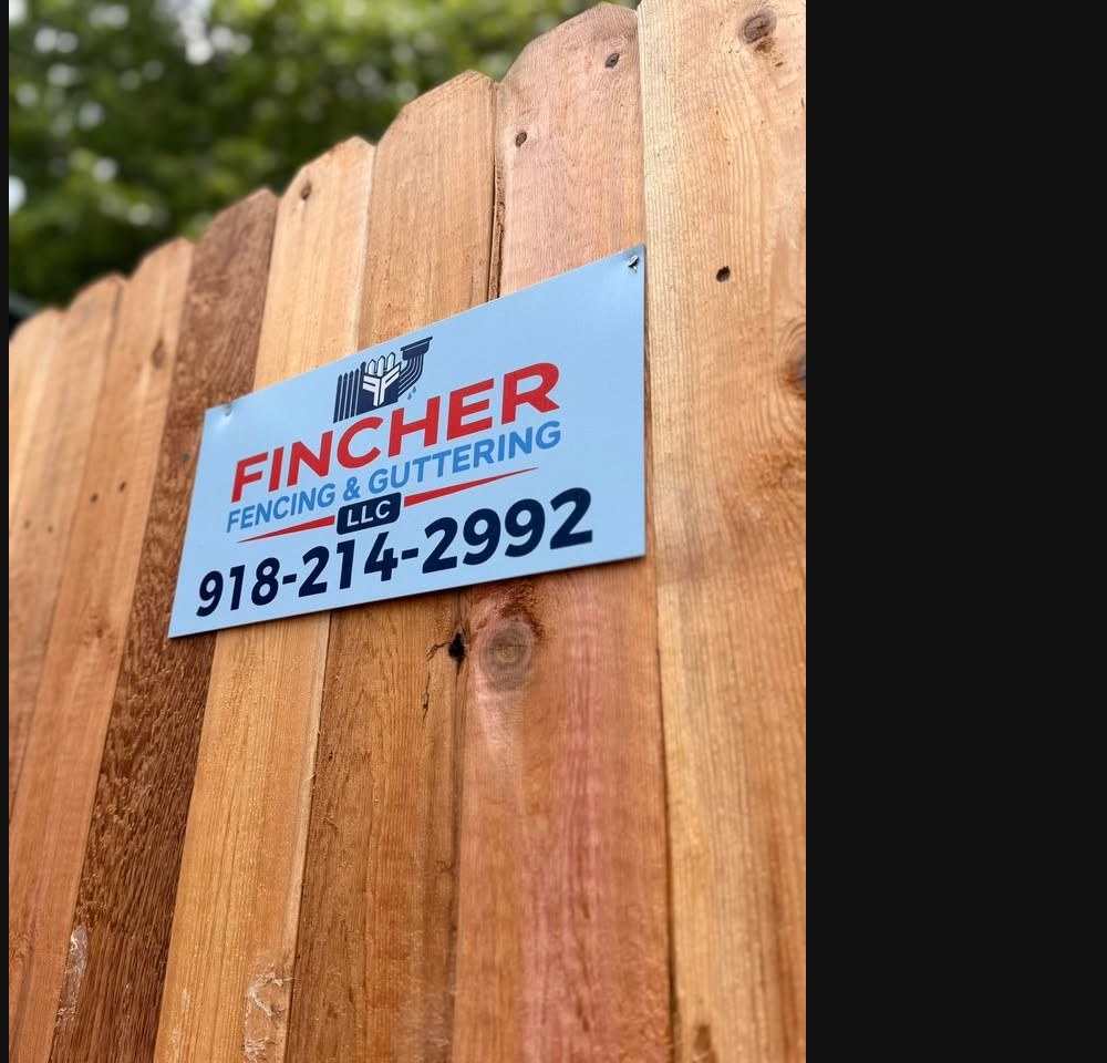 New wood privacy fence with Fincher Fencing sign