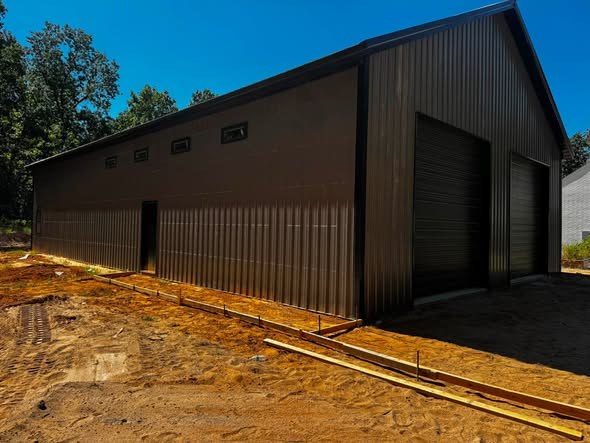 Pole barn with form boards set for a concrete apron