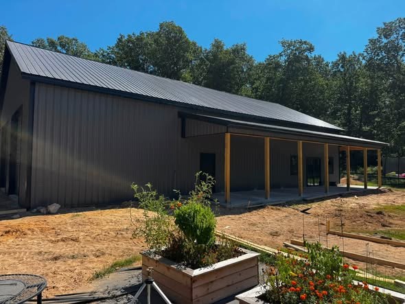 Finished concrete porch slab on a metal shop building