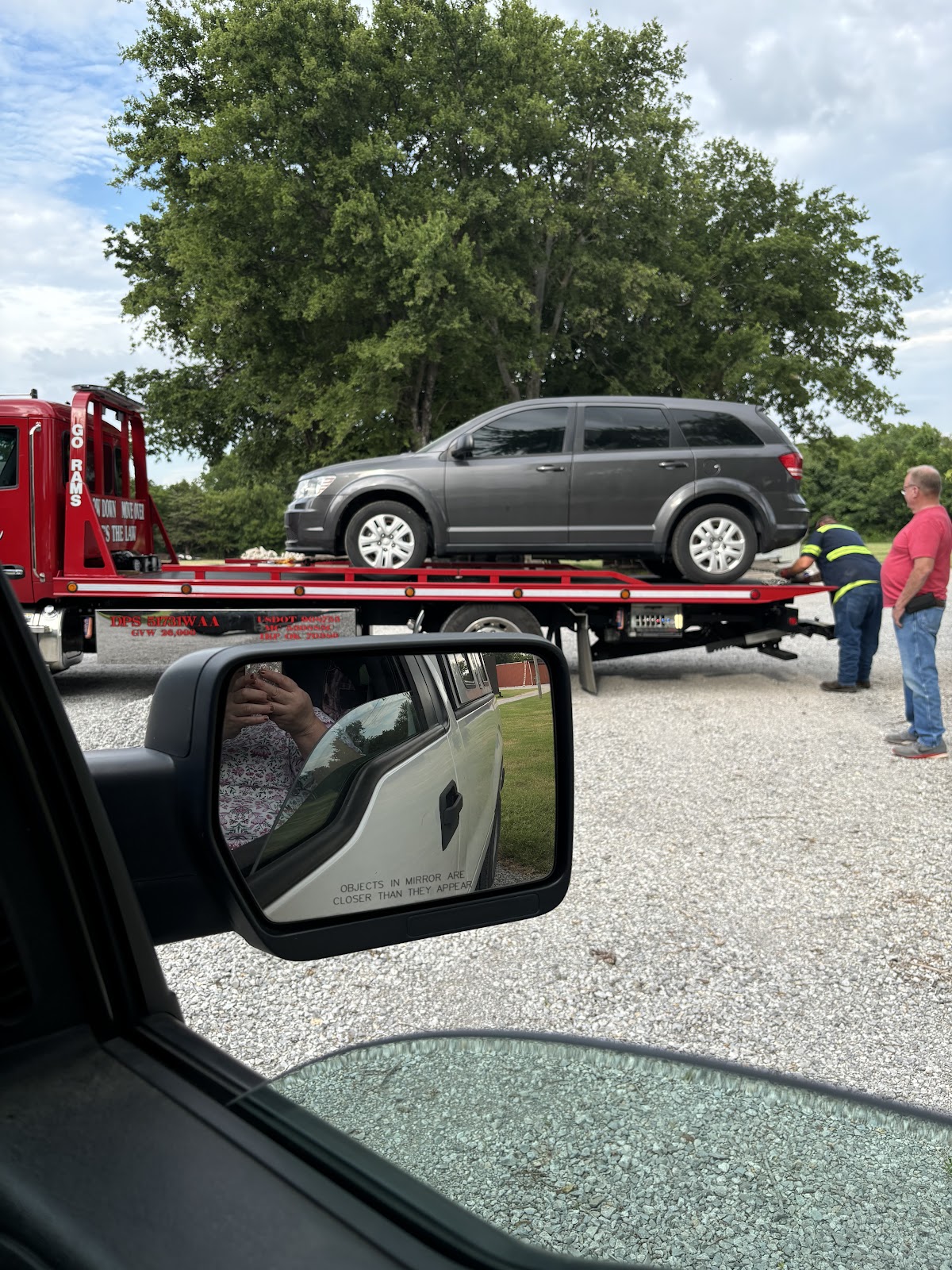 Lenox red flatbed loading an SUV on a job