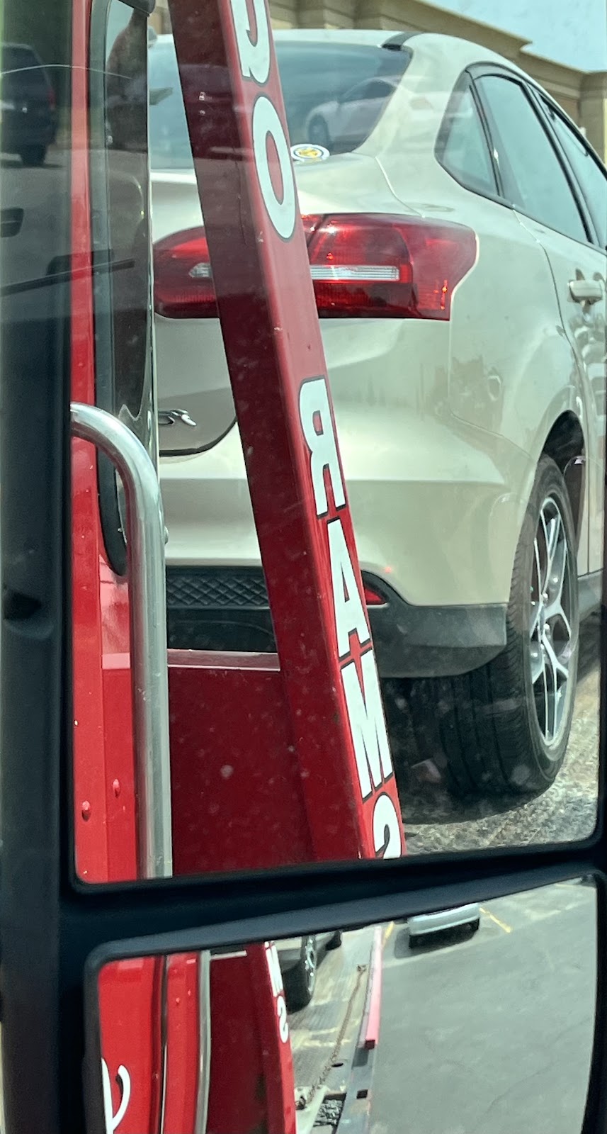 Sedan secured on red Ramsey flatbed