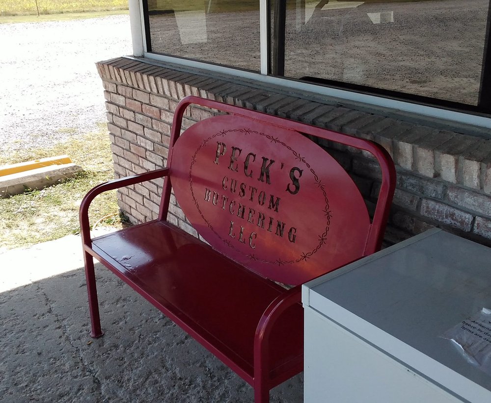 Peck's branded red bench at the shop entrance