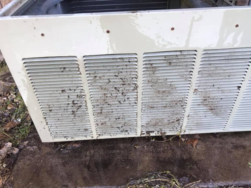 Outdoor condenser unit with clogged louvers before service.